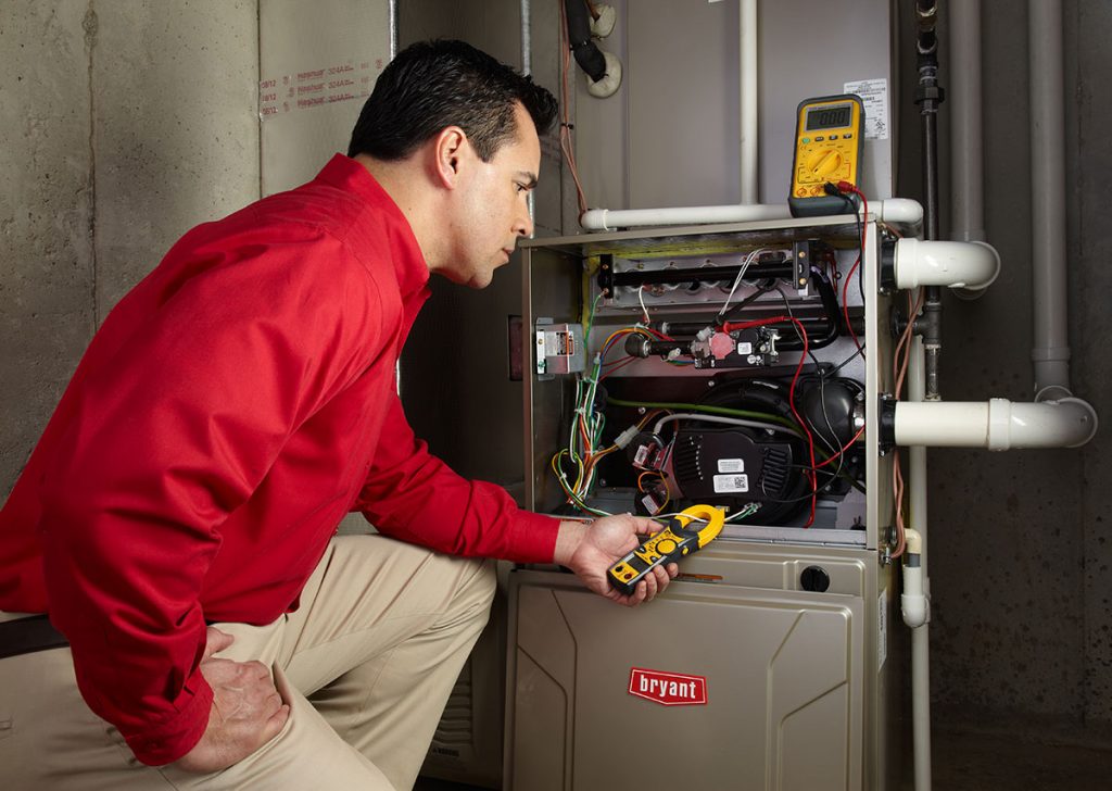 HVAC technician repairing an indoor furnace in Longmont