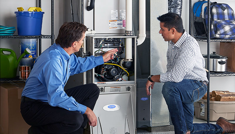 HVAC technician evaluating a furnace for repair or replacement in Longmont