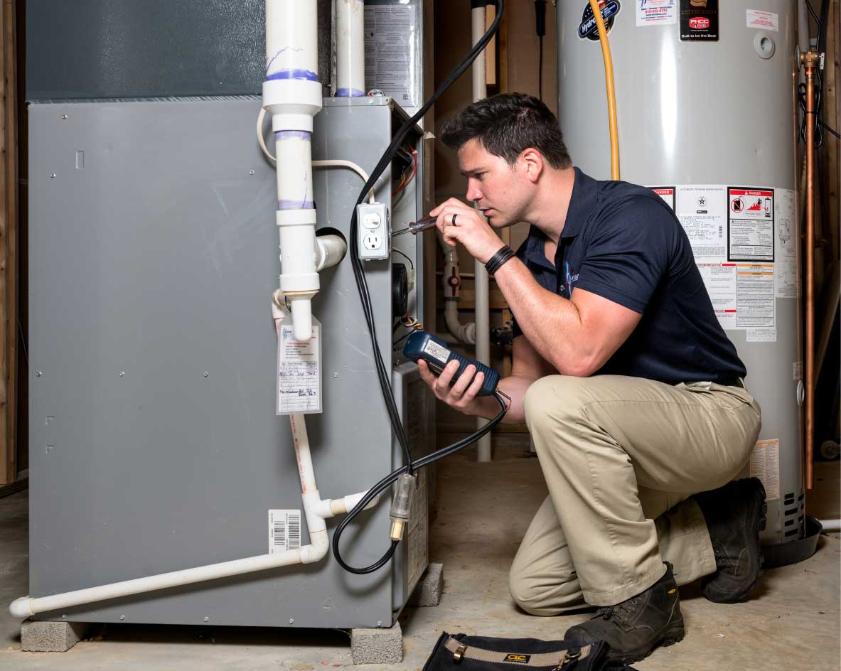 HVAC technician performing a furnace tune-up in Longmont