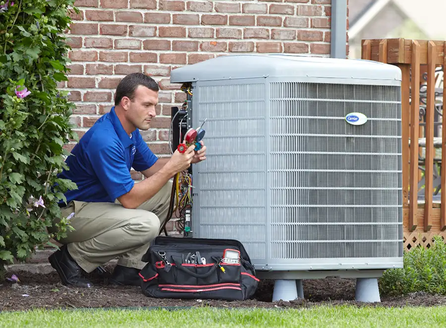 HVAC technician inspecting an outdoor air conditioning unit in Longmont