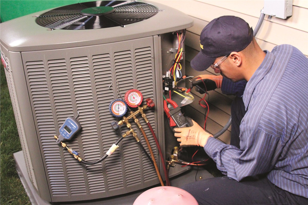 HVAC technician testing an outdoor air conditioning unit in Longmont